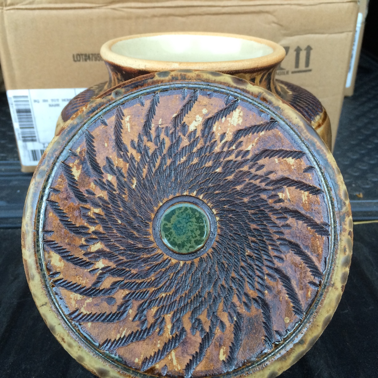 Lidded ceramic jar - lid with spiral pattern, iron oxide glaze, and copper oxide highlight